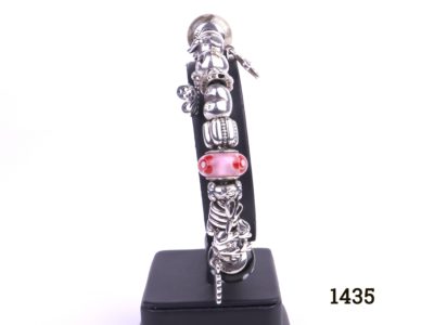 Pandora silver bracelet fully loaded with 22 charms Main photo showing bracelet on display stand