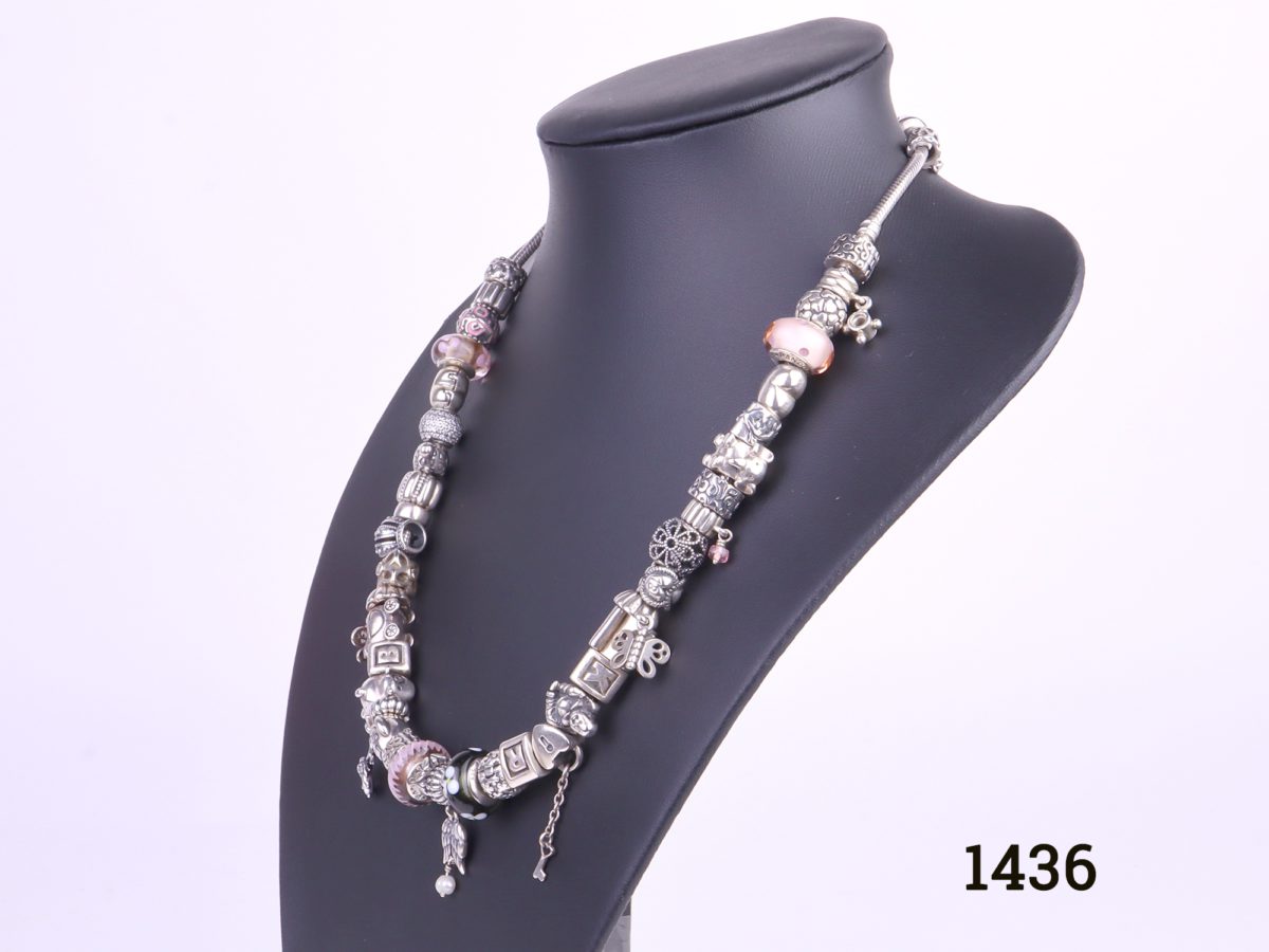 Pandora solid silver necklace fully loaded with 41 charms and a safety catch All hallmarked Ale 925 Photo of necklace from a side angle on display stand