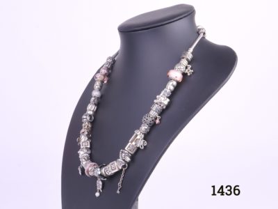 Pandora solid silver necklace fully loaded with 41 charms and a safety catch All hallmarked Ale 925 Photo of necklace from a side angle on display stand
