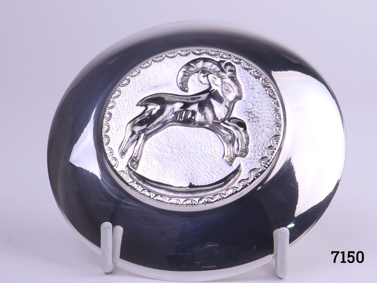Danish silver pin dish with a figure of a ram to the centre Hallmarked Nrn 830 Measures 97mm in diameter Photo of back of dish on display stand