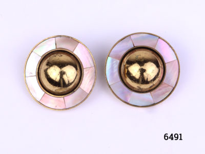 Ermani Bulatti clip-on earrings. Vintage gilt metal circular clip-on earrings with a raised round mound to centre surrounded by inlaid mother-of-pearl (Some gilt wear to centre at front and back). Measures 25mm in diameter Main photo showing front view of both earrings