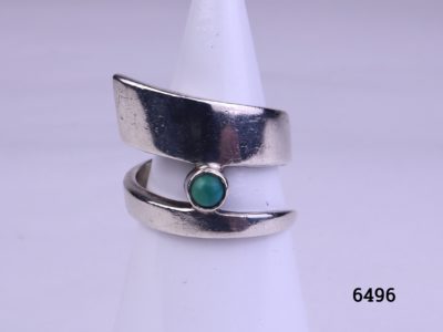 Modernist style vintage silver ring. Vintage sterling silver ring in an asymmetrical twist design with single small turquoise stone accent Size M.5 / 6.5 Main photo showing ring front displayed on a stand