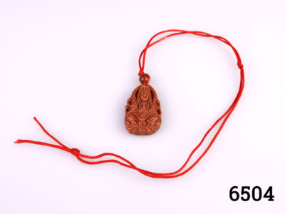 Vintage carved goldstone charm pendant of Guan Yin (The Buddhist Bodhisattva of compassion) Strung on customary red string Charm measures 32mm long by 20mm wide Main photo showing charm with whole length of red string