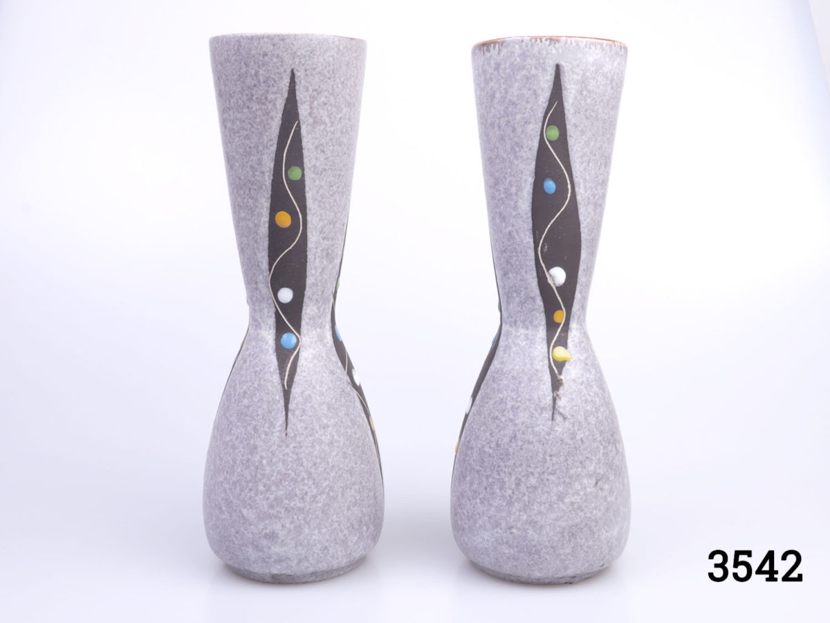 Pair of 1950s small West German vases. Speckled grey pattern with a modernist 'peas in a pod' decoration and reddish brown interior. Each measures 55mm in diameter at base, 57mm across the top and 205mm tall Main photo showing both vases side by side from an eye level angle
