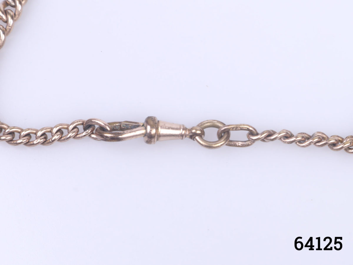 Victorian watch chain and fob in gilt metal with copper decorated fob. Empty fob shield for personalisation. Fob measures 40mm long by 32mm wide Close up photo of the clasp on chain