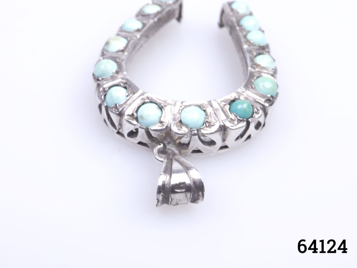 Vintage Egyptian silver horseshoe pendant. Lucky horseshoe encrusted with small turquoise bead stones all the way round. Drop length 45mm from bail Photo of pendant with bail end in the foreground