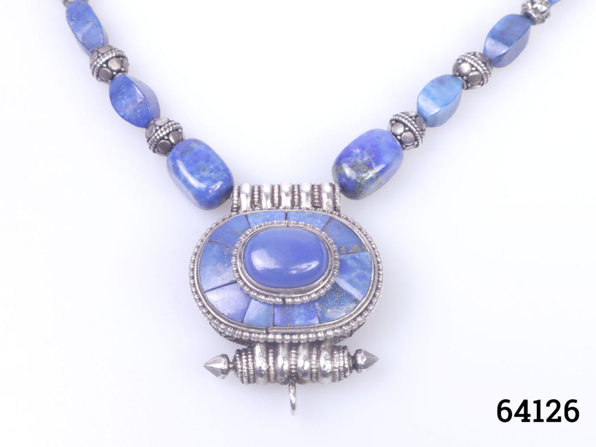 Vintage Tibetan silver necklace with turquoise and lapis lazuli beads and a lapis lazuli box pendant. Pendant has a secret compartment that opens at the back and measures 38mm long by 30mm wide Close up photo of the front of pendant