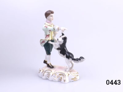 Royal Crown Derby figurine of The Shepherd by Edward Drew. Fully marked to the base. Figure in excellent condition. Main photo of figure seen at a slight angle showing Shepherd facing towards the right and pointing to the lower right & Collie dog facing left