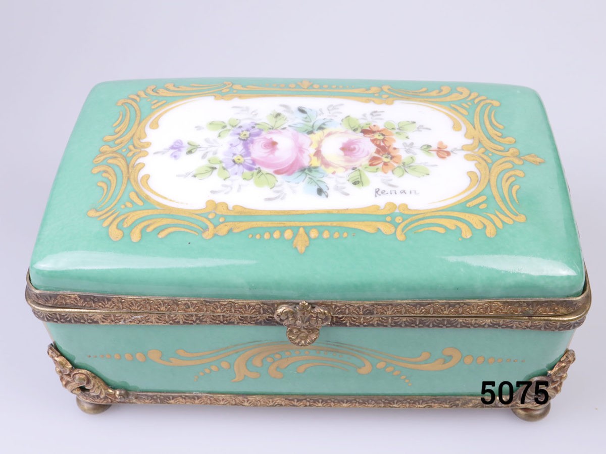 19th Century Paris porcelain box. Hand-painted box in sea green with floral design to centre of the lid with ormolou gilt metal edging and brass feet. Hand-painted picture signed by Renan Photo of the hand-painted floral decoration on the lid and the artists signature to the bottom right