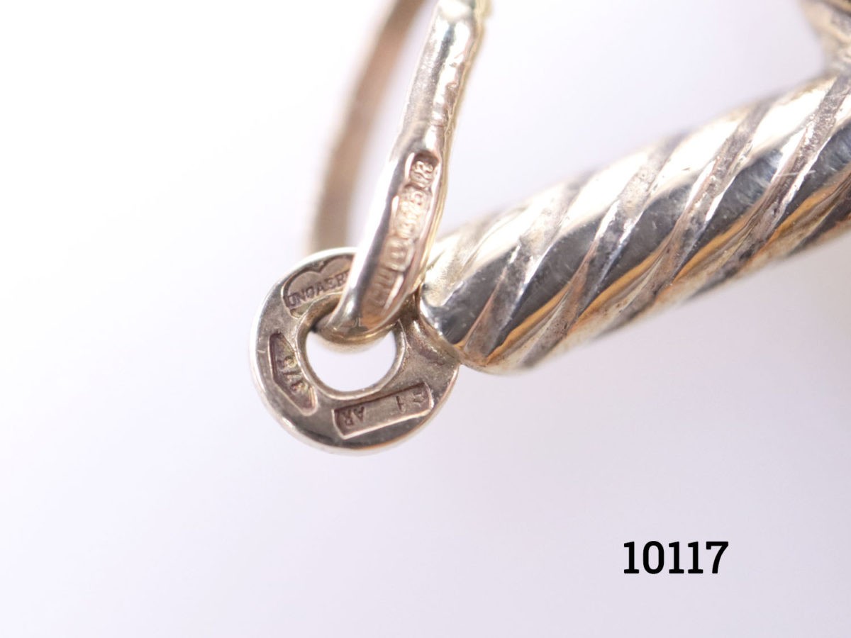Vintage 9 karat gold cross in a rope twist design. Fully hallmarked to the bail for imported gold assay stamped in Sheffield and on the top of the cross. c1975-1998. Drop length 40mm Close up photo of the hallmark on the bail and top of the pendant