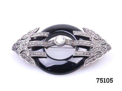 Art Deco style sterling silver and marcasite brooch with a ring of jet to the centre. Will be sent boxed. Brooch measures 62mm long by 35mm wide and weighs 17.7 grams Photo of brooch front shown from a slight upward facing angle