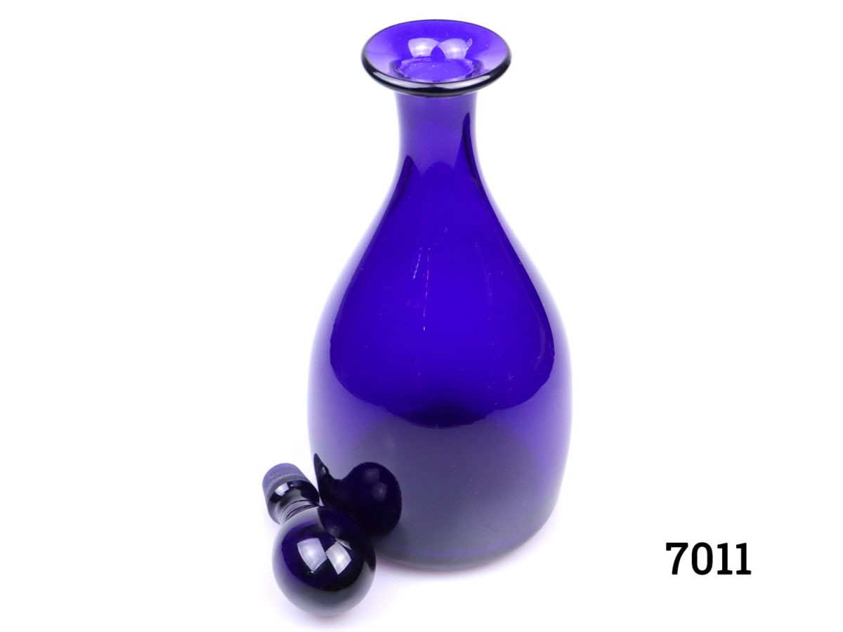 Vintage Thomas Webb Bristol blue decanter. Small chip on the collar. Measures 105mm in diameter at base and 50mm in diameter across the top. Photo of decanter with stropper removed and looking down from a slight height showing collar
