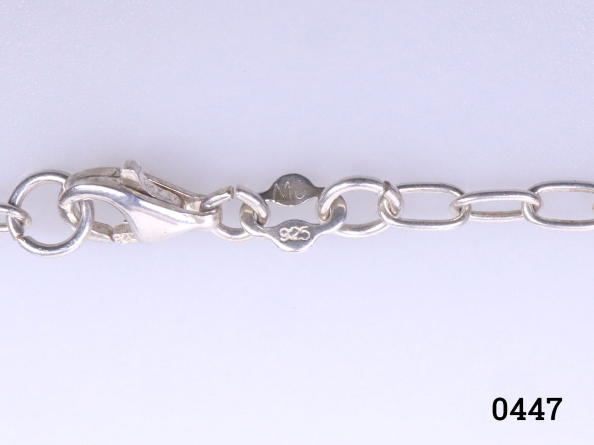 925 Sterling silver chain with a rock quartz crystal heart. A smaller clear crystal heart attached below the quartz heart. Pendant drop length 43mm. Close up photo of the hallmark on the clasp