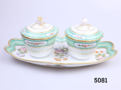 Antique 19th century Paris porcelain double condiment pots on a tray. Identical sized lidded condiment containers attached to a decorative tray. Floral design with peppermint green and gilt. In excellent condition throughout with minor marks inside the pots only. Pots measure 82mm in diameter across the top. Photo of pots with lids in place and seen from a very slightly raised angle