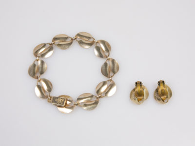 Vintage David Andersen silver and enamel set. Gilt sterling silver and yellow enamel leaf set consisting of clip-on earrings and bracelet. Enamel in excellent order on all pieces. The earring clips are in good working order with the clip part made of metal. Earring front measures approximately 20mm by 15mm. Bracelet measures 85mm in length.  Photo of back of both earrings and bracelet