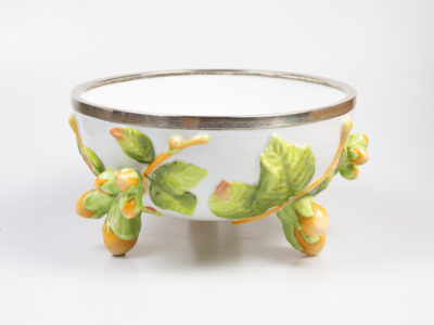 Antique Geman Musterschutz bowl. Large porcelain bowl with embossed decoration of hazelnuts and leaves with the 3 feet also in the form of hazelnuts. Silver plate rim is hallmarked WMFN (Wurttemburgische Metallwarenfabrik Neusilber) with antler and letter O in rhombus. Stamped Musterschutz with the number 30 on the base. Very small dent and slight discolouration of the silver plate rim. Porcelain bowl is in excellent condition with only one very small chip below the silver rim. c1900 Measures approximately 150m apart each foot and 217mm in diameter across the top. Another photo of bowl from an eye level angle with 2 feet visible