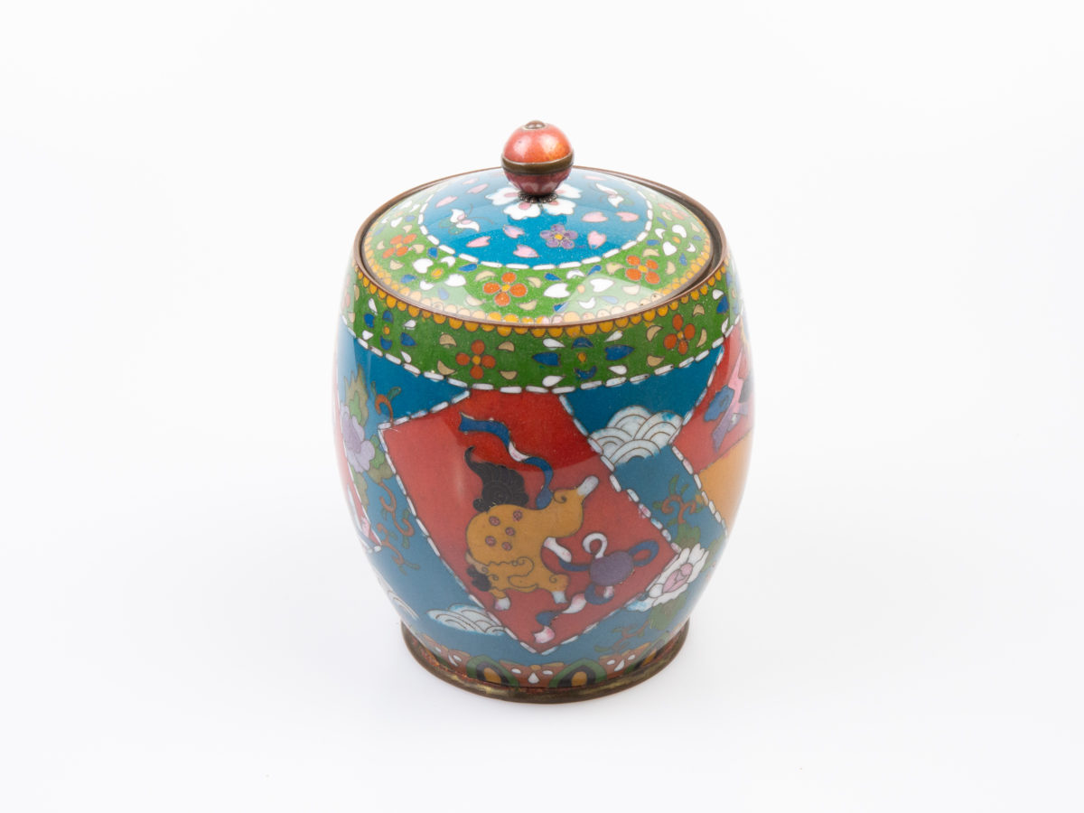 Early 20th century lidded cloisonne jar. Good sized jar in unusually muted colours for cloisonne which adds to the attractiveness of the jar. Decorated with flora and fauna to the side. Enamel in excellent condition. Finial is a little loose on the lid & needs attention. Measures 88mm in diameter at base, approximately 120mm in diameter at widest part and 165mm tall with lid. Photo of jar with ox decoration side shown