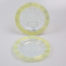 Pair of Art Deco glass side dishes. Handmade small shallow dishes with an unusual colour pattern of pale blue star burst to the centre and yellow green rim. Some minor signs of wear. Each dish measures approximately 100mm in diameter at base, 165mm across the top and 15mm in depth. Main photo showing one dish upright on a stand and other laid flat in front