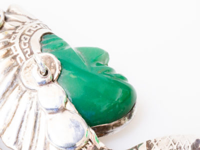 925 Sterling silver brooch by Plata. Intricate design brooch of an Inca warrior in profile with Mexican apple green jade colour Bakelite face and headgear adornment and moving silver earring. Signed Sterling Plata 925 Mexico to the back. Close up photo of the warriors green face