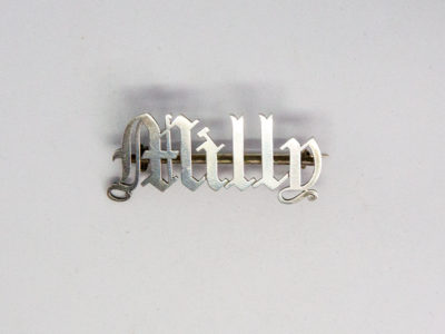 Victorian sterling silver name brooch. Name brooches were highly fashionable in the Victorian era. Beautifully crafted in sterling silver, this one in gothic style is for Milly - lucky Milly! Hallmarked to the back but mostly obscured by the bar pin which is a later addition. Main photo of brooch seen from the front