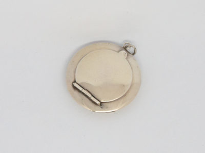 Small circular sterling silver compact. Vintage Art Deco chateleine compact with mirror and puff. Hallmarked for Birmingham assay (date stamp not readable). Measures 45mm in diameter. Main photo of compact taken from above looking down with hinge area to the bottom left and attaching ring to the top right.