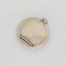 Small circular sterling silver compact. Vintage Art Deco chateleine compact with mirror and puff. Hallmarked for Birmingham assay (date stamp not readable). Measures 45mm in diameter. Main photo of compact taken from above looking down with hinge area to the bottom left and attaching ring to the top right.
