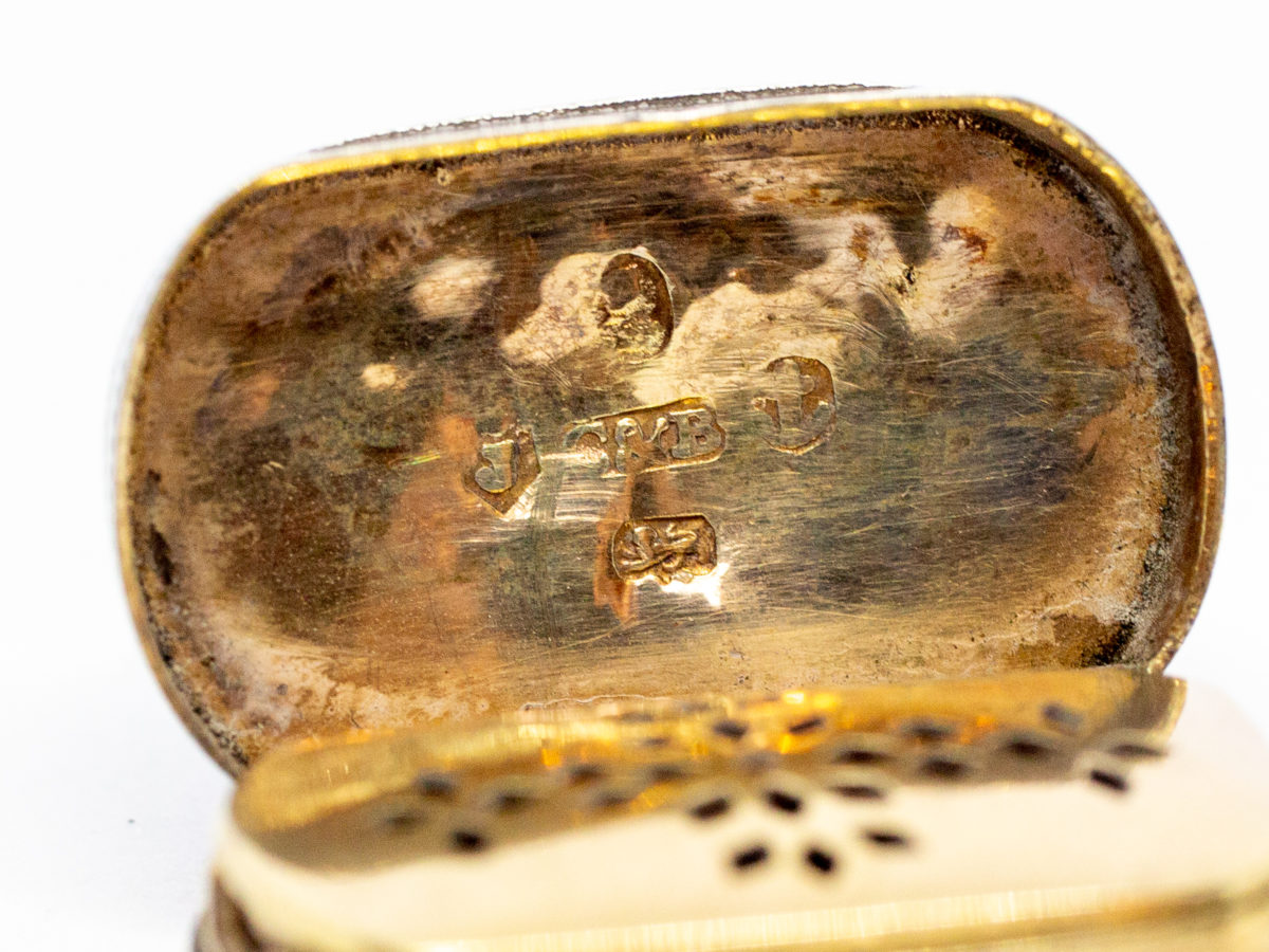 c1807 George III silver vinaigrette. An oblong sterling silver vinaigrette with a curved bottom and a gilt silver interior and grille. Fully hallmarked to the inside of lid for Birmingham assay by silversmith Cocks & Bettridge. A couple of minor dings but closes tight. Close up photo of the hallmark on the inside lid