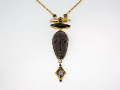 Modern necklace by designer Vicki Sarge. Fantastic statement necklace by famous designer Vicki Sarge in gold plate with Swarovski crystals and wood. The designer has been photographed wearing one very similar to this. Comes in original pouch and box and with original invoice. Drop length of pendant is 155mm, the wooden face measures 78mm. Necklace length is adjustable from 520mm at shortest to 570mm at longest. Close up photo of the hanging/pendant area of necklace