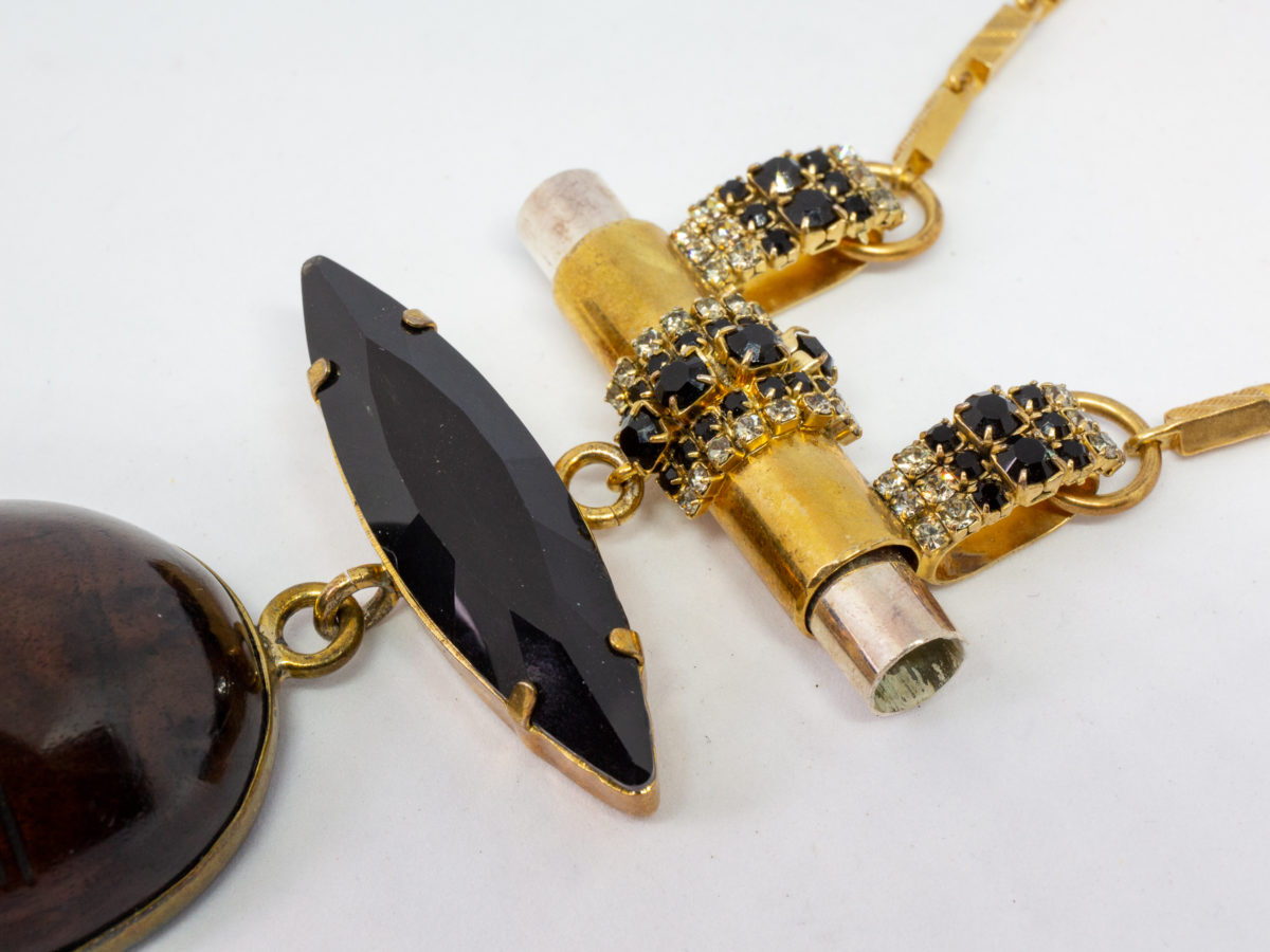 Modern necklace by designer Vicki Sarge. Fantastic statement necklace by famous designer Vicki Sarge in gold plate with Swarovski crystals and wood. The designer has been photographed wearing one very similar to this. Comes in original pouch and box and with original invoice. Drop length of pendant is 155mm, the wooden face measures 78mm. Necklace length is adjustable from 520mm at shortest to 570mm at longest. Close up photo of Swarovski crystals above the wooden face of pendant area.