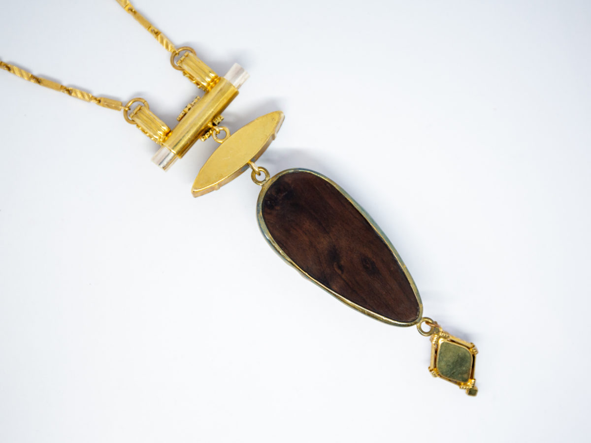 Modern necklace by designer Vicki Sarge. Fantastic statement necklace by famous designer Vicki Sarge in gold plate with Swarovski crystals and wood. The designer has been photographed wearing one very similar to this. Comes in original pouch and box and with original invoice. Drop length of pendant is 155mm, the wooden face measures 78mm. Necklace length is adjustable from 520mm at shortest to 570mm at longest. Photo of back of main hanging pendant area of necklace.