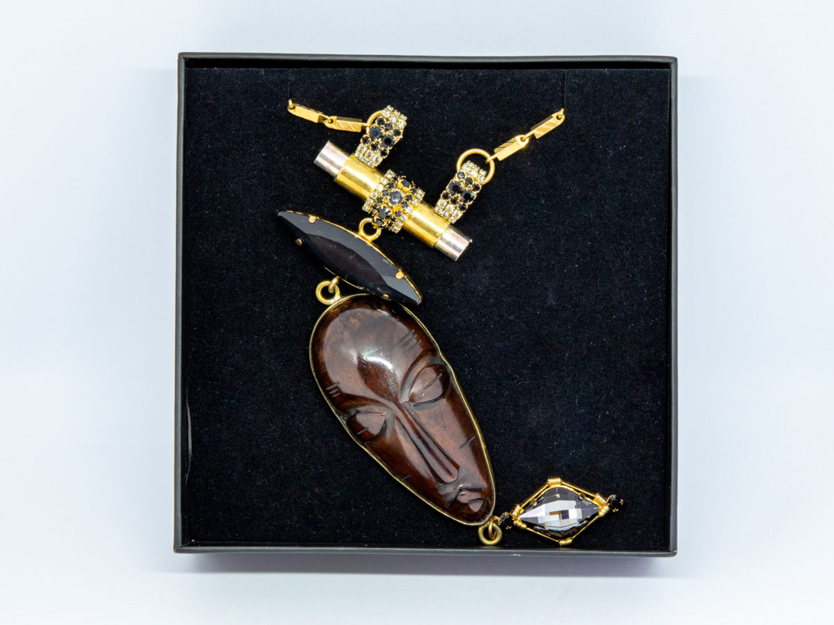 Modern necklace by designer Vicki Sarge. Fantastic statement necklace by famous designer Vicki Sarge in gold plate with Swarovski crystals and wood. The designer has been photographed wearing one very similar to this. Comes in original pouch and box and with original invoice. Drop length of pendant is 155mm, the wooden face measures 78mm. Necklace length is adjustable from 520mm at shortest to 570mm at longest. Photo of necklace displayed inside its box.