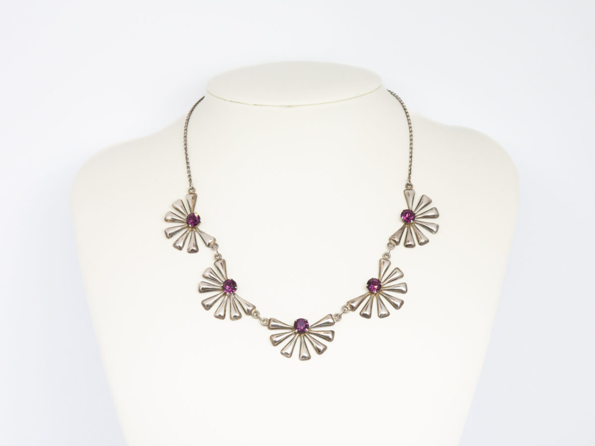 Each daisy measures approximately 30mm wide by 20mm deep. Main photo of necklace displayed on a stand with daisies in a row at the front.
