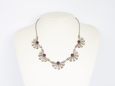 Each daisy measures approximately 30mm wide by 20mm deep. Main photo of necklace displayed on a stand with daisies in a row at the front.