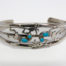Vintage Navajo silver cuff bracelet. High quality cuff bracelet in sterling silver with Kokopelli characters decorated with Sleeping Beauty turquoise stones. Hallmarked sterling to the back and signed by the designer Ella Peter. Really lovely piece of Native American jewellery. Cuff opening measures 30mm but can be slightly manipulated. Main photo of cuff bracelet front showing the Kokopelli musicians and Sleeping Beauty turquoise stones
