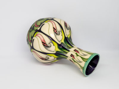 Moorcroft 'lily come home' vase. Modern Moorcroft vase designed by Emma Bossons in a repeated design pattern of white lily flowers. Signed and dated to the base. Measures 80mm in diameter at base, 120mm in diameter at most bulbous part and 57mm in diameter across the top. Photo looking straight down into the vase from above. Photo showing the base of the vase with makers mark and dates.