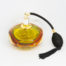 Mid century modern perfume atomiser by Murano. A beautiful piece of Sommerso glass art in shades of clear amber and pale green with a brass top and long spray atomiser in black. Interesting shape with 4 sides giving a look akin to squashed bubble. Measures 52mm in diameter at base and 105mm at bulbous central area. Main photo showing perfume atomiser bottle from a slightly raised eye level with the black spray atomiser to the right of bottle.