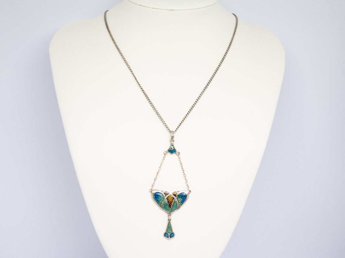 Art Nouveau style resin pendant and chain. Pretty necklace with a modern Art Nouveau style pendant. The pendant is sterling silver with coloured plastic resin to resemble enamel with drop length of 84mm from top of bail and width of 32mm at widest. Hallmarked R&SD sterling to the back. Main photo of necklace displayed on a stand and seen looking straight on.