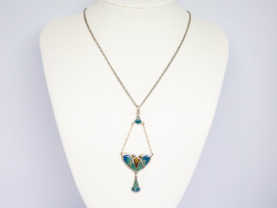 Art Nouveau style resin pendant and chain. Pretty necklace with a modern Art Nouveau style pendant. The pendant is sterling silver with coloured plastic resin to resemble enamel with drop length of 84mm from top of bail and width of 32mm at widest. Hallmarked R&SD sterling to the back. Main photo of necklace displayed on a stand and seen looking straight on.
