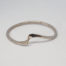 Modern sterling silver snakeskin bangle. Unusual bangle with snakeskin like pattern and a flat twist on one area giving a double snake like appearance. Fully hallmarked for London assay c2015. Inside diameter measures 65mm. Main photo of bangle on a flat surface with the 'Snake head and tail' in the foreground.