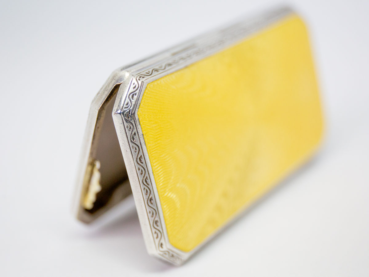 Ladies guilloche enamel and silver cheroot case. Stunning ladies Art Deco cheroot case with yellow guilloche enamel to one side. 925 hallmark for sterling silver in several areas. Gilded interior. In wonderful condition throughout and closes tight. Missing the elasticated band inside. Import mark for Glasgow c1925. Made by Scholl Ltd. Photo of case open and stood up at opening end outlining the edging.