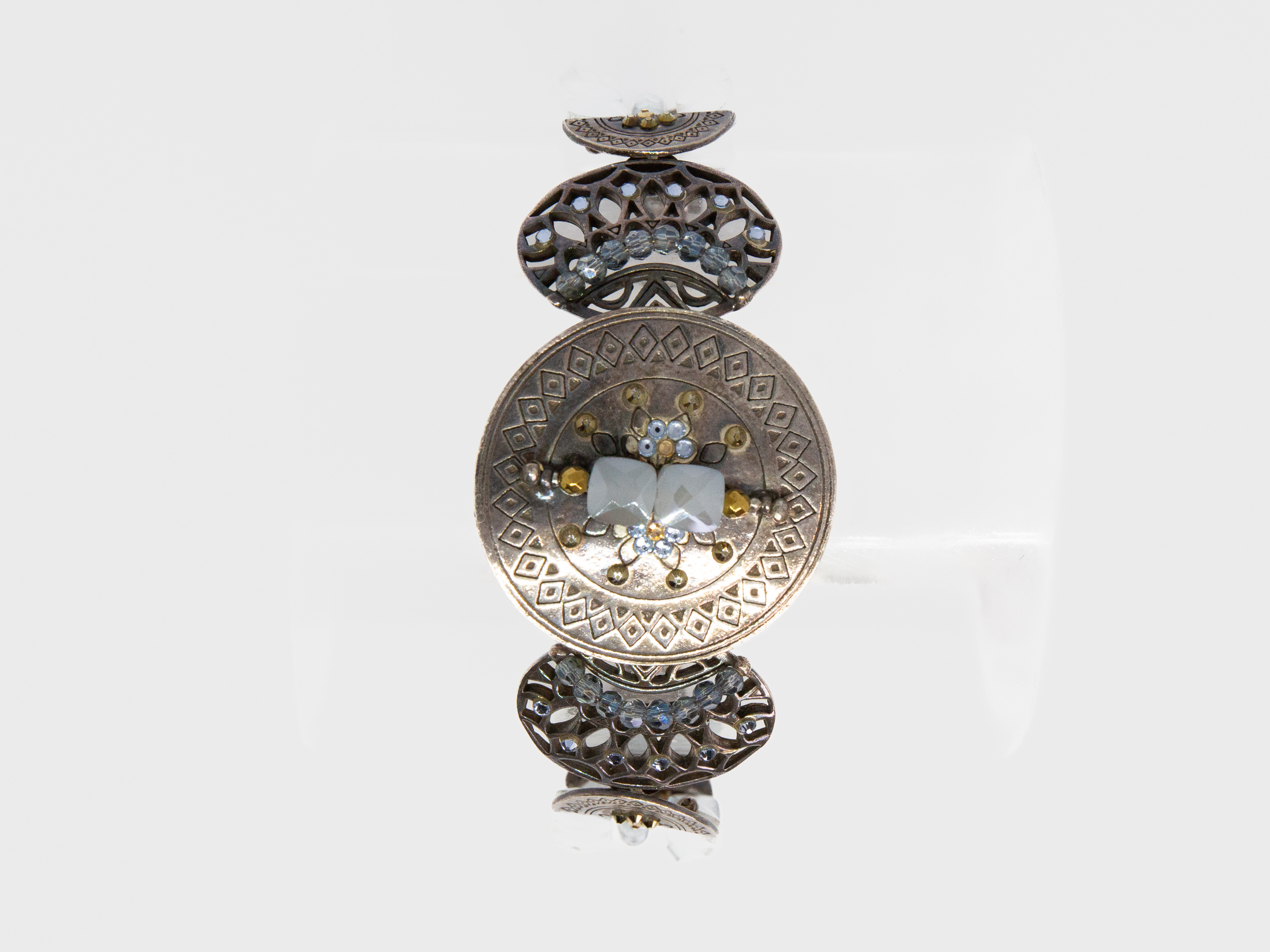 Modern Swarovski bracelet by Taratata. Very pretty bracelet evocative of ancient civilisations. Metal base set with smoky blue and gold Swarovski crystals. Made in France. Central disk measures approximately 37mm in diameter. Picture of the bracelet with circular centre adorned with stones facing the front.