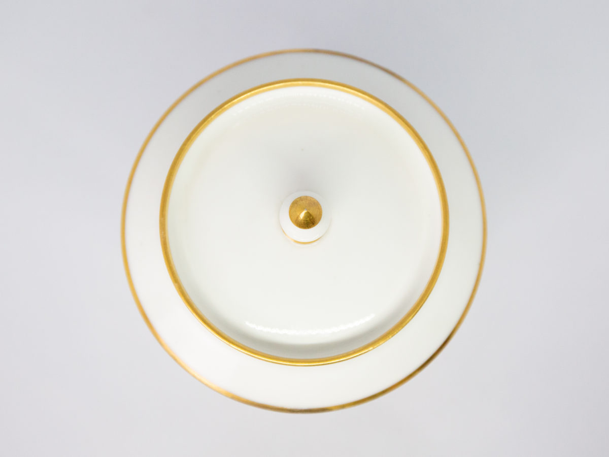 c1890 Dore a Sèvres lidded pot. Fine quality antique lidded pot in white porcelain with gilt accent. In excellent condition for its age. Stamped to base. Measures 85mm in diameter, top opening measures 95mm in diameter and lid overhangs at 102mm in diameter. Photo of pot with lid in place and looking straight down from above.