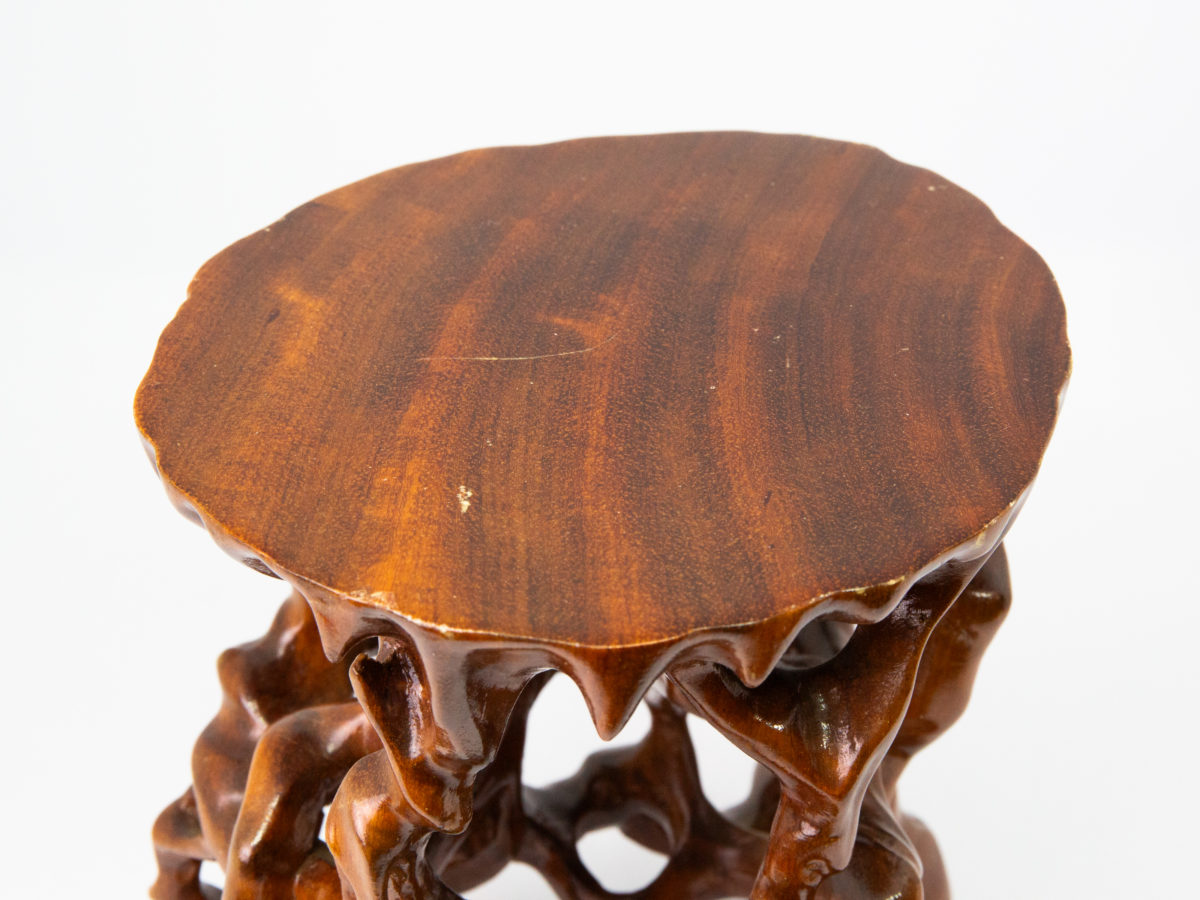 Vintage Chinese carved root stand. A carved hardwood root form stand finished in a hard wearing glossy varnish. Some minor scuff marks to the flat top. Measures 145mm long and 135mm wide at base. Flat top area measures 140mm at longest and 125mm at widest. Close up photo of the flat surface area of stand showing a couple of minor marks.