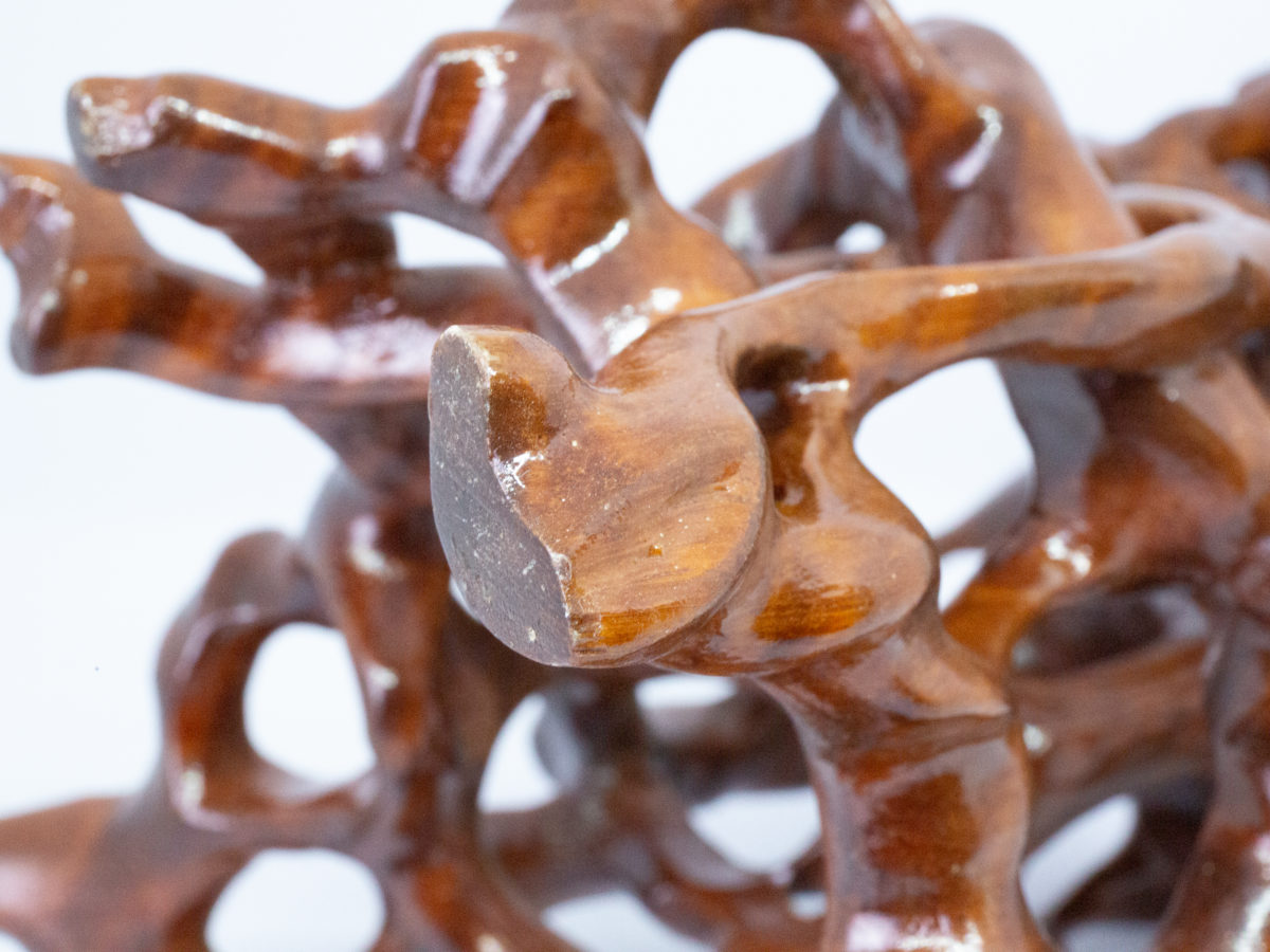 Vintage Chinese carved root stand. A carved hardwood root form stand finished in a hard wearing glossy varnish. Some minor scuff marks to the flat top. Measures 145mm long and 135mm wide at base. Flat top area measures 140mm at longest and 125mm at widest. Close up photo of one of the legs showing some scratch marks.
