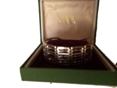 Hallmarked London 1977. Sterling silver 70's " gate" bracelet. With heart padlock. Very good condition. In original fitted box. Main photo of bracelet displayed inside its fitted case. (Image of bracelet is a little blurred)