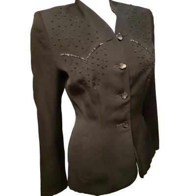 1940s black fitted jacket with bead embellishment on front. In excellent condition. Size 10. Photo of jacket shown at a slight angle to the right