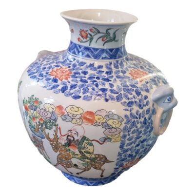 The vintage Chinese pot is highly decorative featuring a selection of polychrome enamels around the body, and lion heads to either side. The pot measures 350mm in height and 280mm in width. Main photo showing pot from a slight side angle with main image side facing left and one of the lion head handles to the lower right of photo.