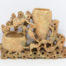 Vintage Oriental soapstone brush pot. Wonderful brush pot with a scene of wildlife gorging on lotus roots and seeds. 2 pots for brushes which are both engraved with a foliage design. Taller pot has crack across the base and both pots have sustained chips. Slight wobble from uneven base. Measures approximately 195mm at base, 35mm at widest and 132mm at tallest. Main photo showing decorative side of pot from a near eye level angle with larger of the brush pots to the right.