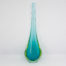 Vintage turquoise glass vase by Murano. Striking slender sommerso glass vase by Murano in stunning turquoise with vibrant sea green to the lower sides. The aesthetically stunning shape is akin to a drop of water and is very pleasing to the eye. A wonderful vintage glass art attributed to Flavio Poli. c1960s. Base measures 42mm by 30mm, the bulbous lower are measures 90mm wide by 60mm deep and top measures 12mm in diameter. The opening at top is very small measuring approximately 6mm in diameter. Main photo of vase with widest and flattest side shown and vibrant green to lowers sides visible.