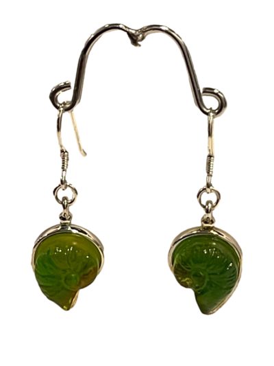 "Sound of the Ocean" earrings by Liuli Gong Fang. Made in sterling silver and green pâte-de-verre crystal in the form of a shell. Drop length approximately 40mm. Main photo of earrings displayed on a stand and facing forward.